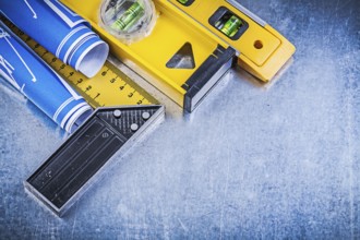 Blue engineering drawings construction levels square ruler on metallic background