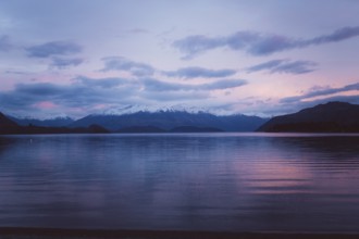 Mountain scenery at sunset with reflection in a calm lake, Milford Sound, New Zealand, Oceania