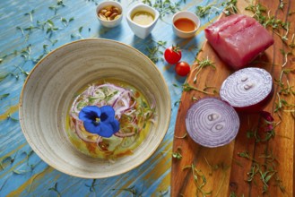 Fish ceviche latin preuvian recipe on bowl with pansy flower
