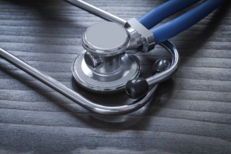 Wooden board with diagnostic medical stethoscope close up image medicine concept
