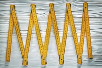 Yellow wooden meter on white board