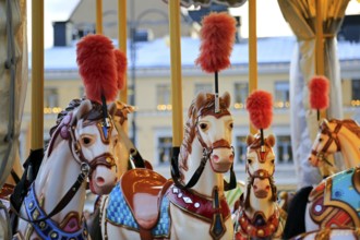 Colouful carousel horses on a traditional merry-go-round on Helsinki Christmas Market, Helsinki,