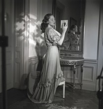 Viveca Lindfors. Swedish-American Actress. 1920-1995. She is looking at herself in two mirrors to