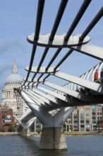 Pedestrians crossing Millennium Bridge over the River Thames, St. Paul's Cathedral, London,