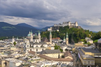 Summer view of the historic centre of Salzburg with Hohensalzburg Fortress and cloudy sky,