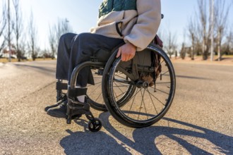 Person using wheelchair enjoying a sunny day in a park, promoting inclusion and accessibility for