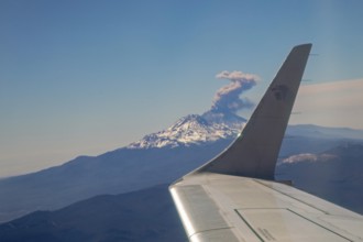 Mexico City, An AeroMexico jet flies past the erupting Popocatepetl volcano