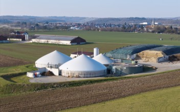 Green fields and a biogas plant in a quiet rural setting with a village, near Backnang,