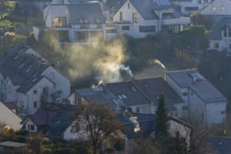 Symbolic image, pollution, global warming, climate change, smoke from chimneys in a residential