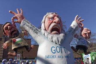God figure grabs an Israeli and a Palestinian by the ear, themed float on the Gaza War by Jacques