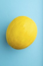 Ripe yellow melon on blue pastel background. Top view, flat lay, close up. harvest, healthy, vegan