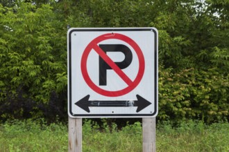 Large white, black and red No Parking with Left and Right direction arrows pictogram notice sign