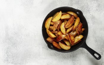 Fried potato slices, in a cast-iron pan, homemade, no people
