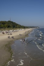 Sandy beach beach with beach chairs and tourists, view from the pier, Heringsdorf, Usedom Island,