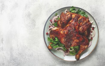 Whole fried chicken, with spices, grilled chicken, on a light background, top view, homemade, no