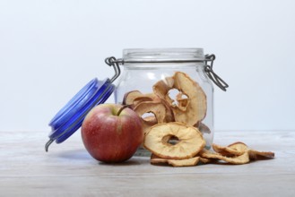 Apple and dried apple rings in glass containers, dried fruit