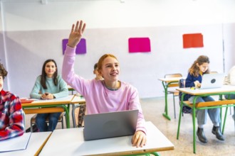 Smart student raises her hand to ask a question during class, showing engagement and participation