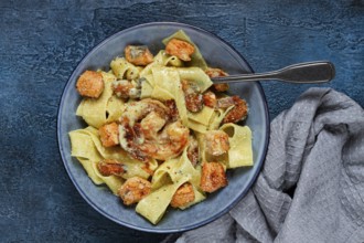 Papardelle pasta in creamy sauce with seafood, homemade, no people