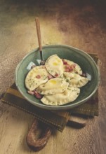 Dumplings, with fried prosciutto, a traditional dish of Polish cuisine, dumplings, top view,