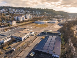 View of industrial area with solar panels and surrounding hills, Nagold, Black Forest, Germany,