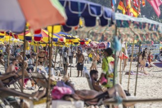 Overtourism in Thailand. Mass tourism on the sandy beach of Patong, the deckchairs are packed