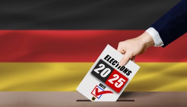 Hand holding ballot in voting ballot box with German flag. Germany presidential elections