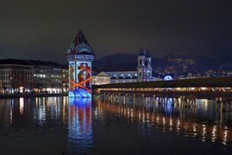 Wassertum with light installation, Chapel Bridge on the right, Jesuit Church on the Reuss at dusk