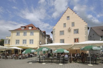 Historic armoury with stepped gable and street pub, cannon, sunshades, lakeside promenade,