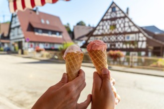 Eating ice cream in summer in the medieval mountain village of Sasbachwalden, Black Forest,