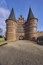 City gate, historic brick building, footpath made of sand, Holstentorplatz, Hanseatic city of