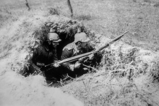 Two 1916 WWI German Landsturm soldiers with Pickelhaube, spiked helmets in foxhole, dugout on World