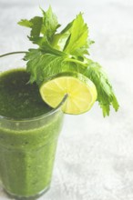 Glass with green smoothie, celery and spinach, apple and kiwi, cucumber, vegetable smoothie,