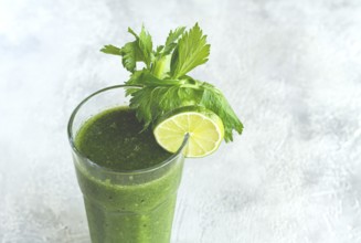 Glass with green smoothie, celery and spinach, apple and kiwi, cucumber, vegetable smoothie,