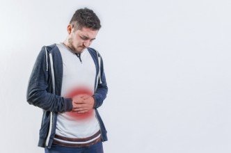 Unhappy man with digestive problems isolated. Person with digestive and stomach problems isolated