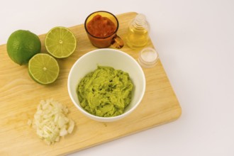 Crushed avocado in a white bowl. Recipe to prepare a nice guacamole