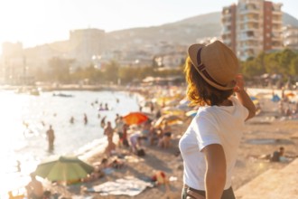 Portrait of a tourist woman at sunset in Sarande or Saranda on the Albanian riviera, Albania,