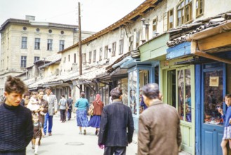 People walking along street of small shops, Sarajevo, Bosnia and Herzegovina, former Yugoslavia,