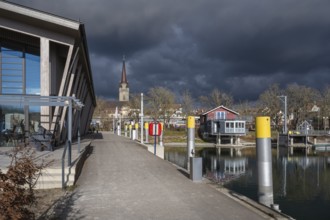 The harbour pier and the marina of Radolfzell on Lake Constance, behind it the cathedral tower,