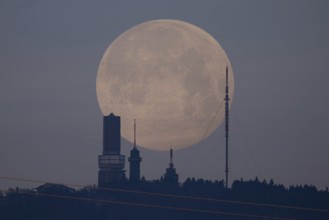 The first full moon of the year, also known as the wolf moon, disappears behind the Großer Feldberg