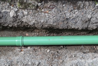 Newly laid green sewage pipe in a trench, Stuttgart, Baden-Württemberg