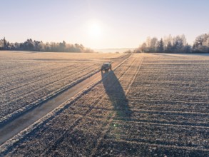 A vehicle on a frost-covered road in the rural sunrise, car sharing, electric car, Volkswagen ID 5,