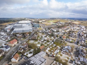 Bird's eye view of industrial area and neighbouring residential buildings in winter landscape,