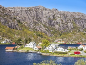 Steep granite mountains at the sea near Ana Sira, village Stornes, typcial coastal village, at