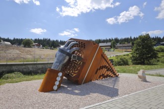 Sculpture bandoneon with hand, strap and buckle as a monument and symbol of musical instrument