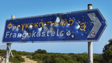 Road sign, bullet holes, shot up road sign, Frangokastello, Venetian fortress, fortress, Sfakia,
