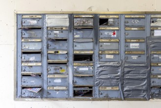 Doorbell sign, broken letterbox system on a dilapidated block of flats in Stuttgart,