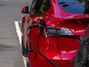 Red electric car at a charging station, Berlin, Germany, Europe