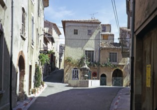 Attractive historic buildings in the village street of Venasque, Vaucluse, Provence, France 1974