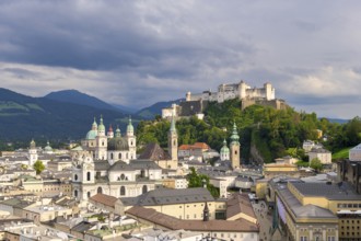 Panorama of the historic centre of Salzburg with Hohensalzburg Fortress and dramatic cloud cover,