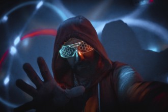 Cyberpunk man with glowing glasses uses augmented reality in futuristic technological environment